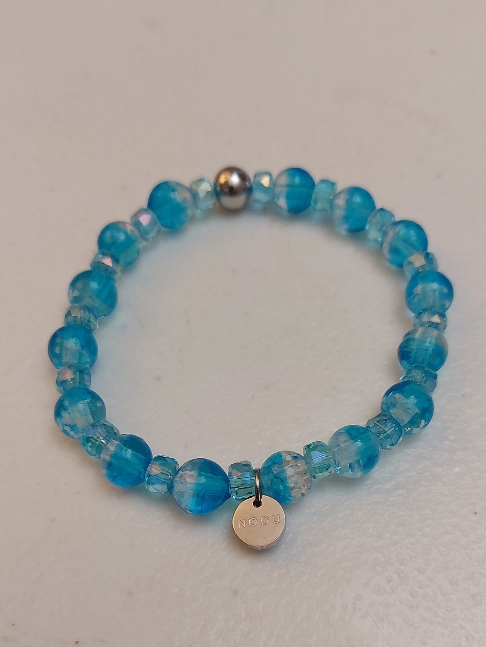 Nogu Artisan Handblown Aquamarine Ice Firefly Glass Snow Globe Stretch Bracelet
